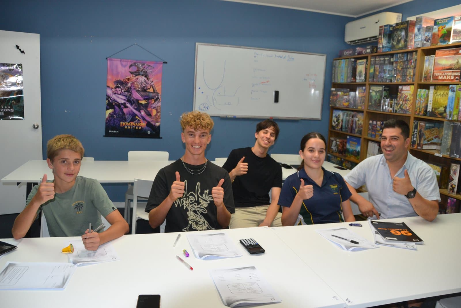 Tutors and HSC students with past papers at a First Education centre
