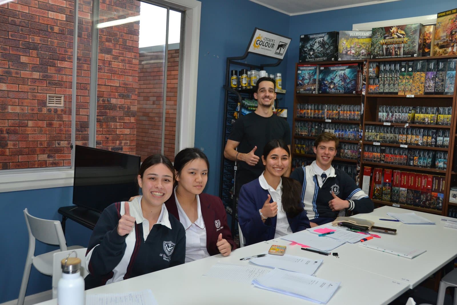 Tutors and HSC students with past papers at a First Education centre