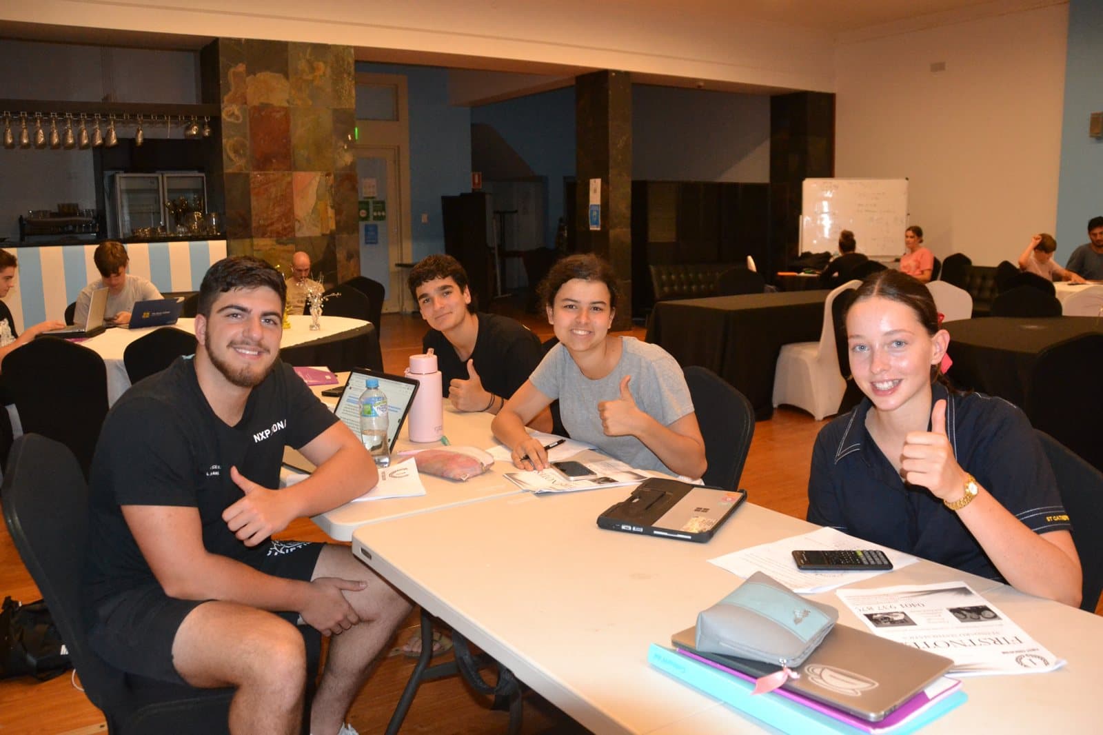 Tutors and HSC students with past papers at a First Education centre
