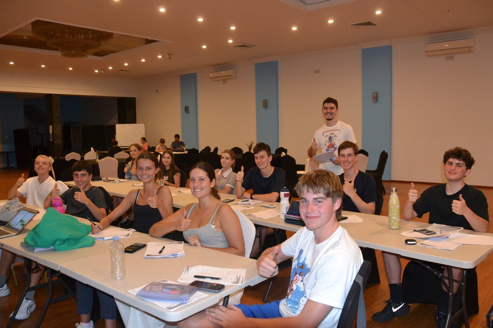 Tutors and HSC students with past papers at a First Education centre