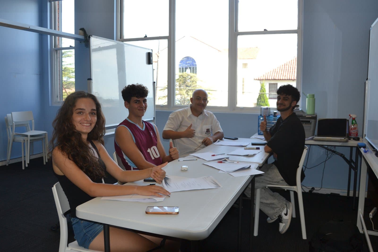 Tutors and HSC students with past papers at a First Education centre