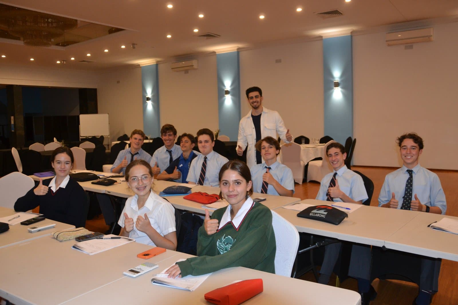 Tutors and HSC students with past papers at a First Education centre