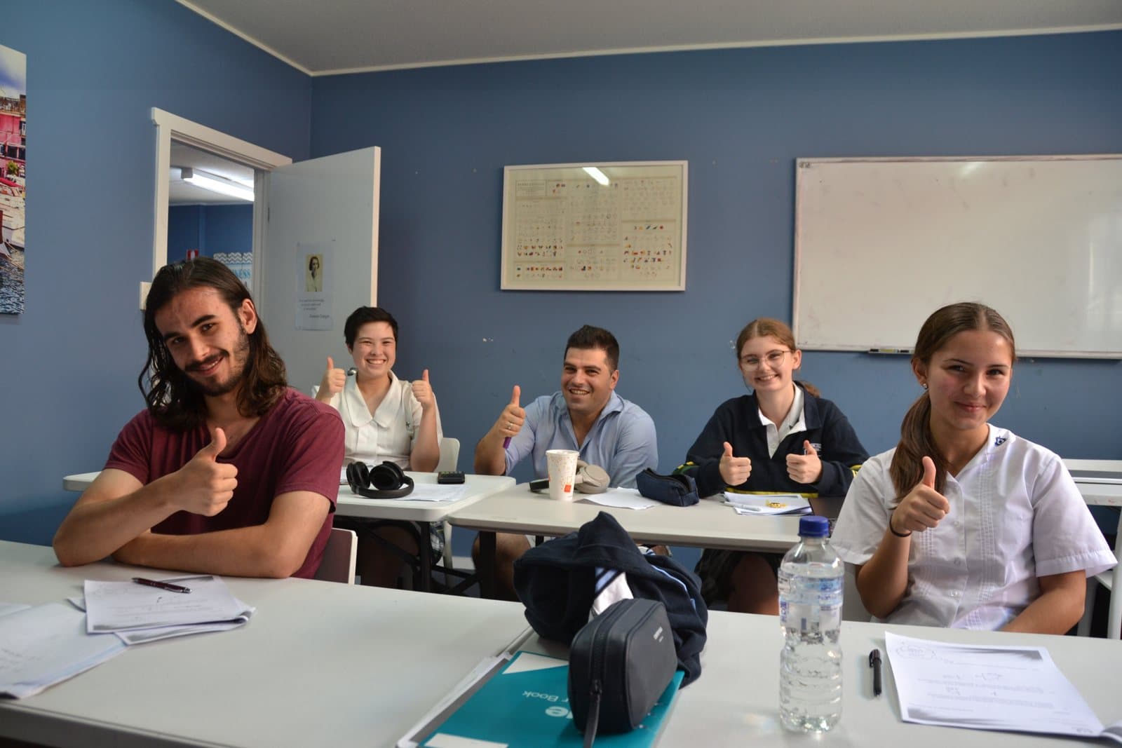 Tutors and HSC students with past papers at a First Education centre