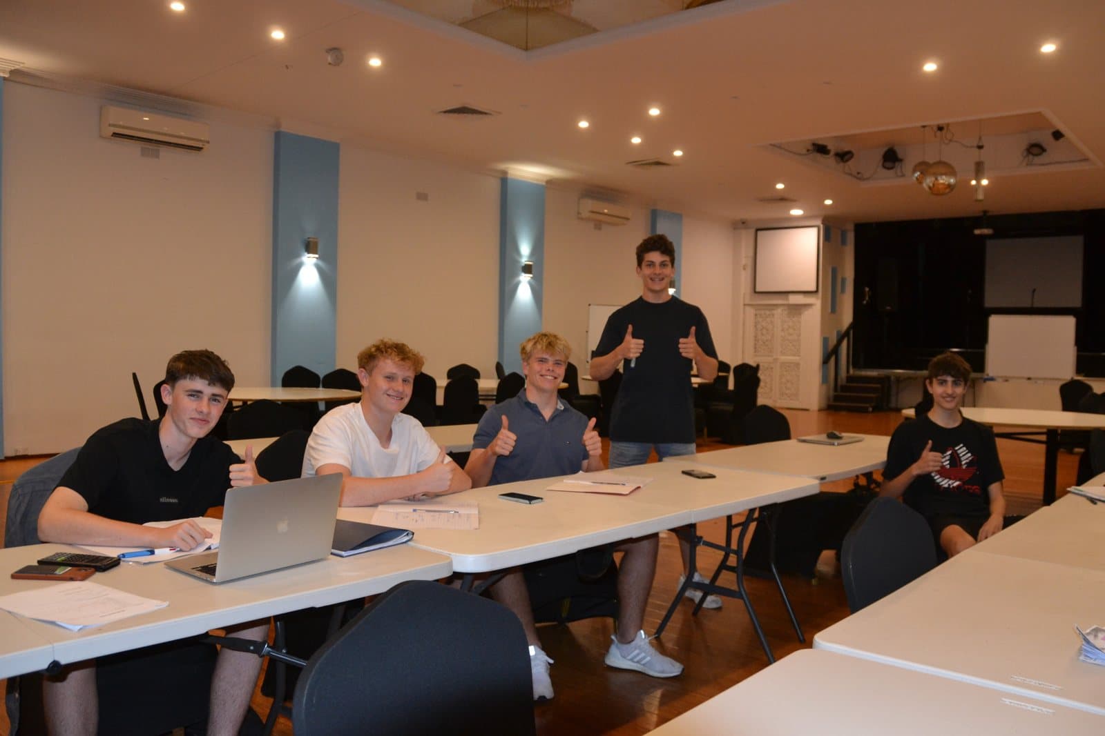Tutors and HSC students with past papers at a First Education centre