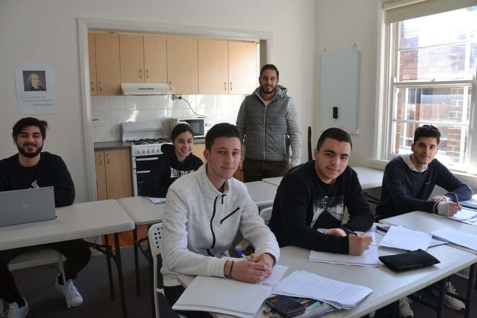 Tutors and HSC students with past papers at a First Education centre